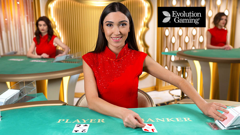 a woman in red at a casino table, smiling whilst laying cards on the table